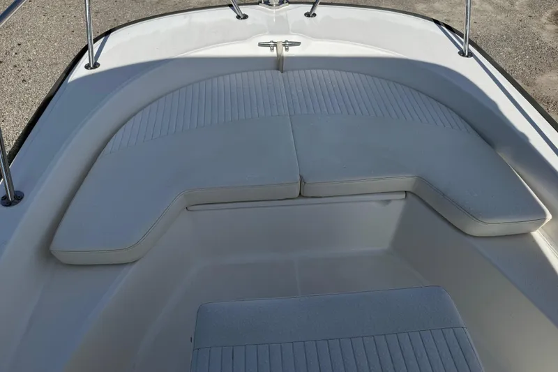 Slide: The Image of 2015 Boston Whaler 170 Montauk boat interior with cushioned seating area. - 23
