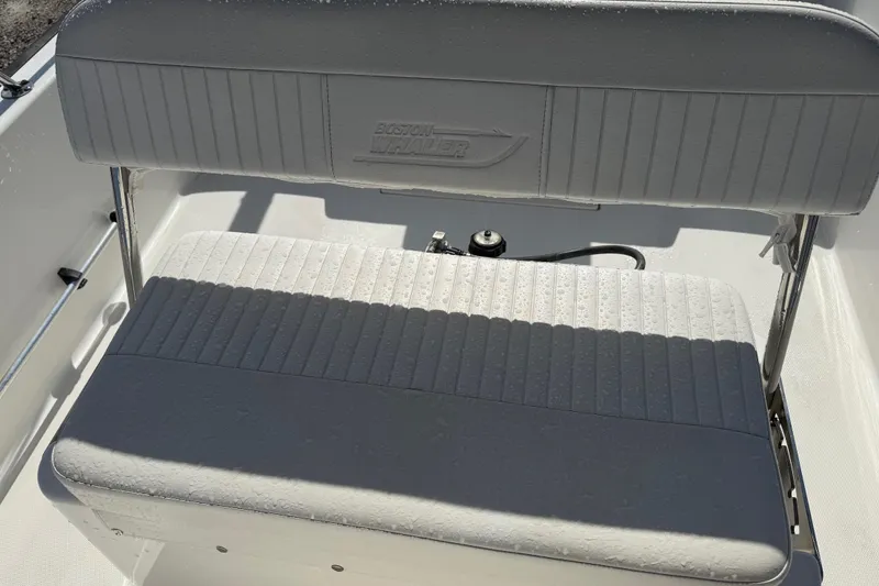 Slide: The Image of Boston Whaler 170 Montauk 2015 boat seat with embossed logo and textured upholstery. - 25