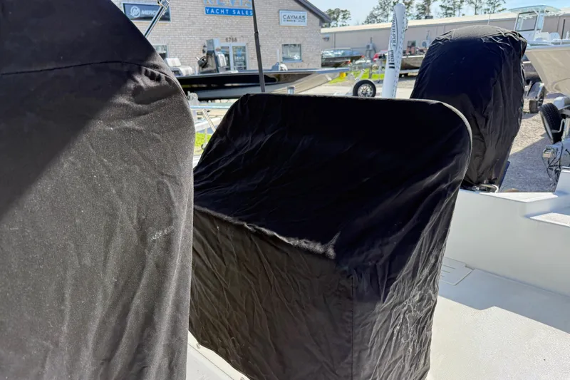 Slide: The Image of 2015 Boston Whaler 170 Montauk boat with black protective covers in a dealership setting. - 27