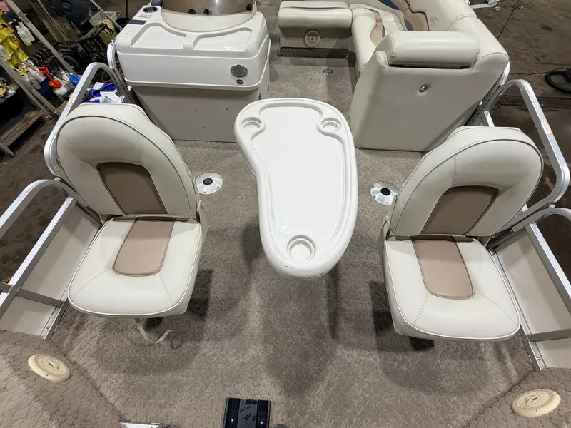 Slide: The Image of Interior of a 2010 Misty Harbor pontoon boat with seating and table. - 12