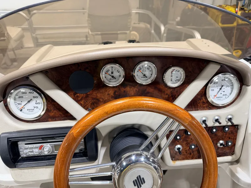 Slide: The Image of Dashboard of a 2010 Misty Harbor boat with wooden steering wheel. - 28