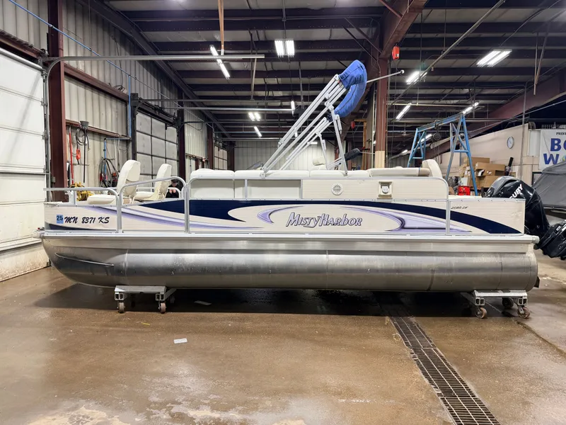 Slide: The Image of 2010 Misty Harbor pontoon boat in warehouse, model 2085DF with Mercury 4-Stroke engine. - 34
