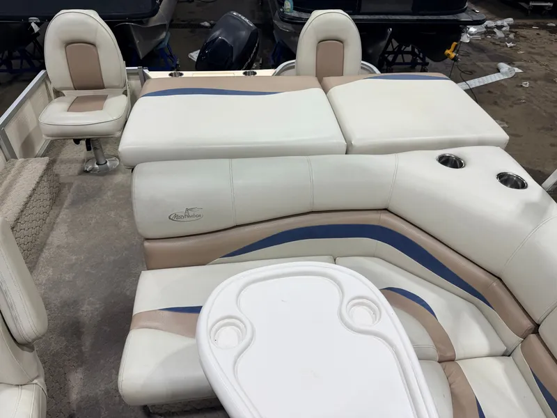 Slide: The Image of Interior of a 2010 Misty Harbor pontoon boat with beige and blue seating. - 41