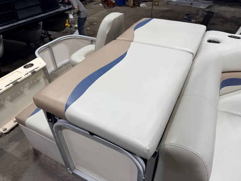 Slide: The Image of Interior of a 2010 Misty Harbor pontoon boat with beige and blue seating. - 42