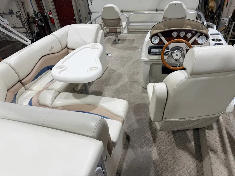 Slide: The Image of Interior of a 2010 Misty Harbor pontoon boat with steering wheel and seating. - 44