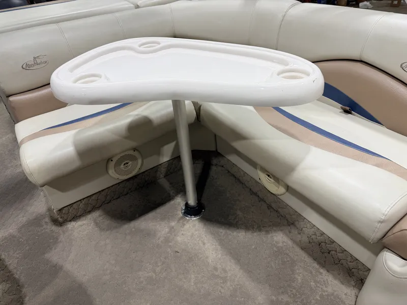 Slide: The Image of Interior of a Misty Harbor pontoon boat with table and seating. - 48