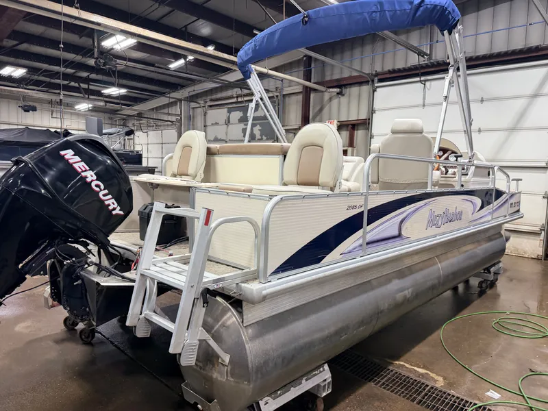 Slide: The Image of 2010 Misty Harbor pontoon boat with Mercury engine in warehouse. - 49