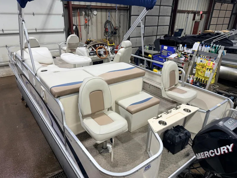 Slide: The Image of 2010 Misty Harbor pontoon boat with Mercury 4-stroke engine in workshop. - 5