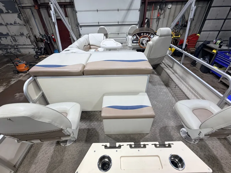 Slide: The Image of Interior of a 2010 Misty Harbor pontoon boat with beige seating. - 6