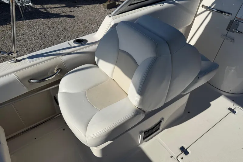 Slide: The Image of 2015 Robalo R227 Dual Console boat seat, white upholstery, sleek design, comfortable seating. - 17
