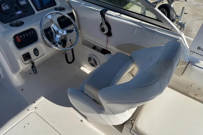 Slide: The Image of 2015 Robalo R227 Dual Console boat interior with steering wheel and control panel. - 22