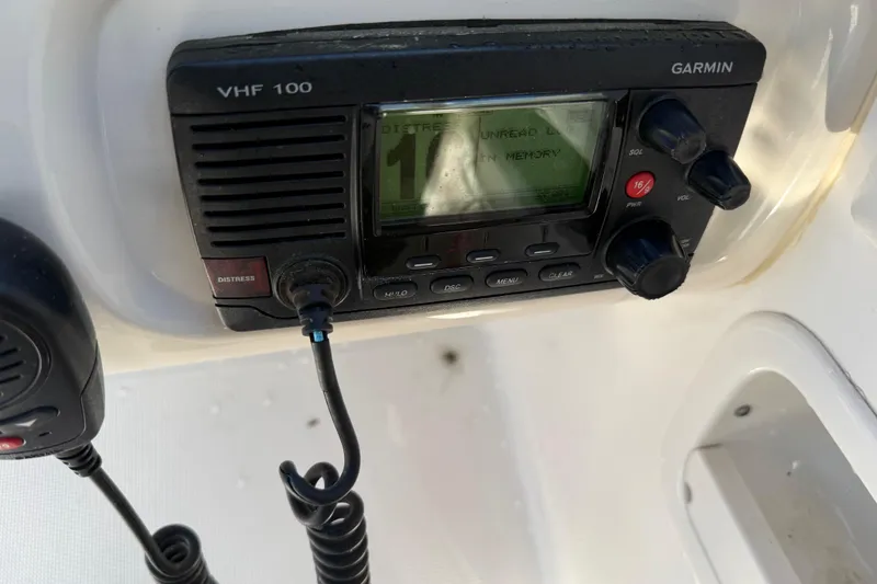 Slide: The Image of Garmin VHF 100 radio on 2015 Robalo R227 Dual Console boat dashboard. - 33