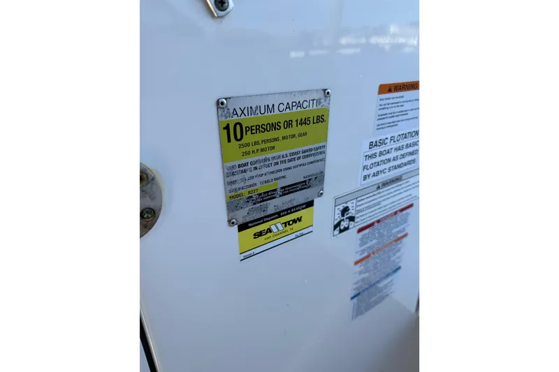 Slide: The Image of Capacity label on 2015 Robalo R227 Dual Console, indicating 10-person or 1445 lbs limit. - 34