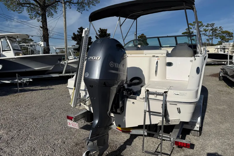 Slide: The Image of 2015 Robalo R227 Dual Console boat with Yamaha 200 engine, parked on gravel. - 6