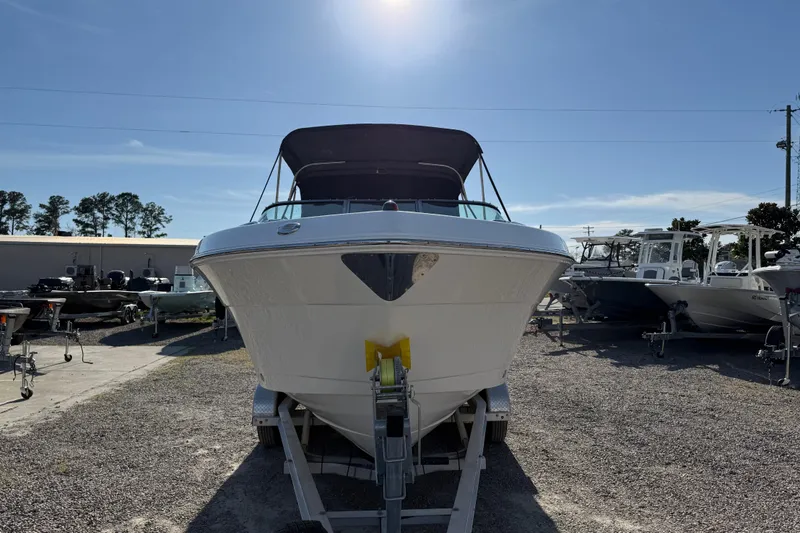 Slide: The Image of 2015 Robalo R227 Dual Console boat on trailer under clear sky. - 9