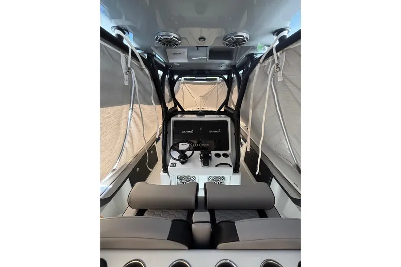 Slide: The Image of 2024 Yellowfin 36 Offshore boat interior with Garmin navigation system and cushioned seating. - 18