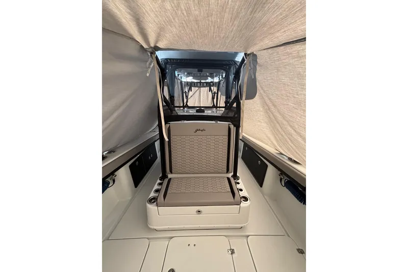 Slide: The Image of 2024 Yellowfin 36 Offshore boat interior with cushioned seating and storage compartments. - 22