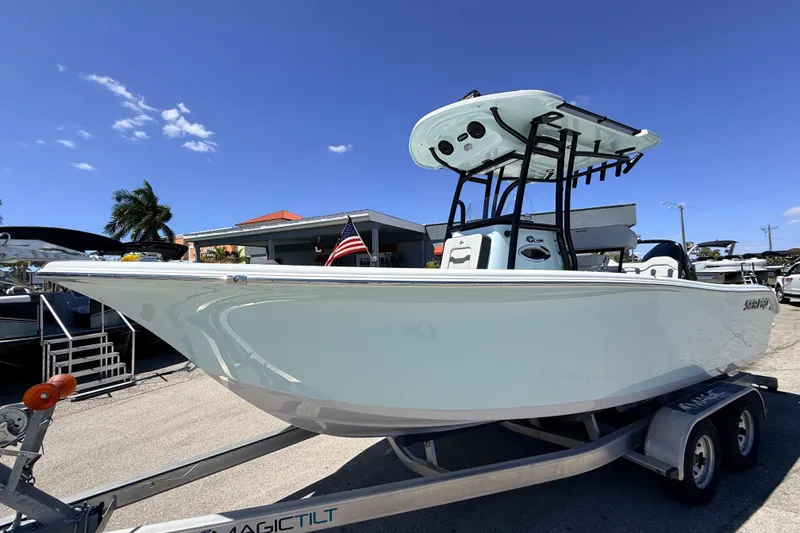 The Image of 2026 Sea Pro 225FLX Sandbar boat on trailer, under clear blue sky. - 1