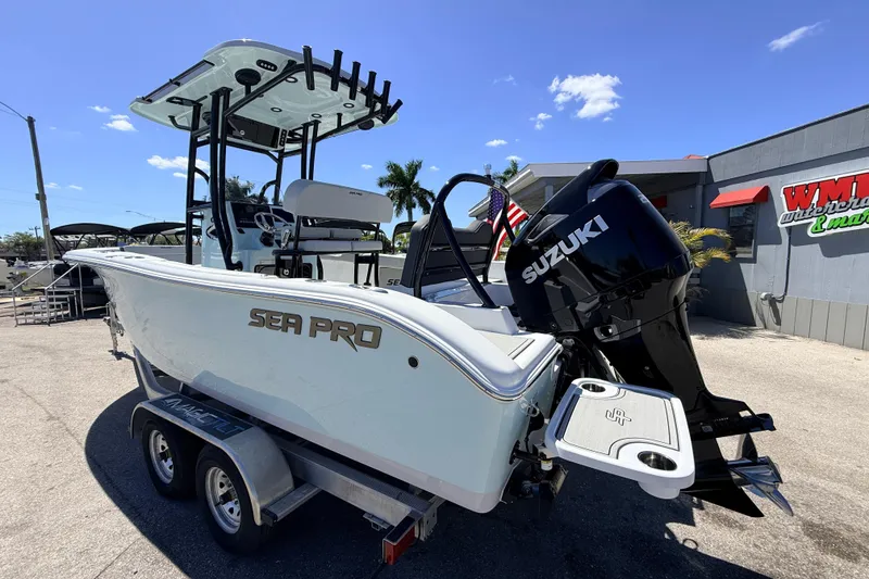 Slide: The Image of 2026 Sea Pro 225FLX Sandbar boat with Suzuki engine on trailer, outdoor display. - 10