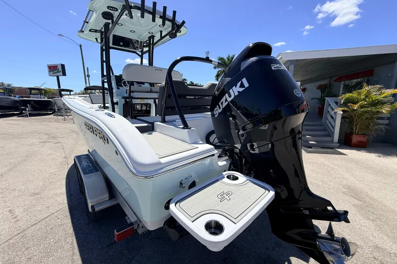 Slide: The Image of 2026 Sea Pro 225FLX Sandbar boat with Suzuki outboard motor, parked outdoors. - 12