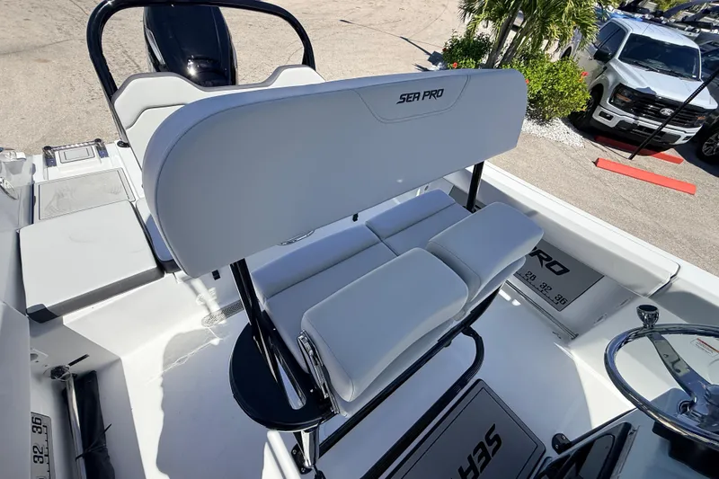 Slide: The Image of 2026 Sea Pro 225FLX Sandbar boat interior with white seating and steering console. - 15