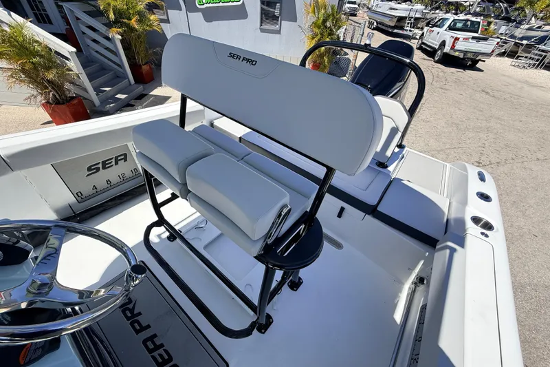 Slide: The Image of 2026 Sea Pro 225FLX Sandbar boat interior with seating and steering wheel. - 23