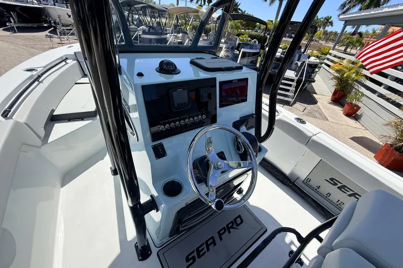 Slide: The Image of 2026 Sea Pro 225FLX Sandbar boat interior with steering wheel and control panel. - 25
