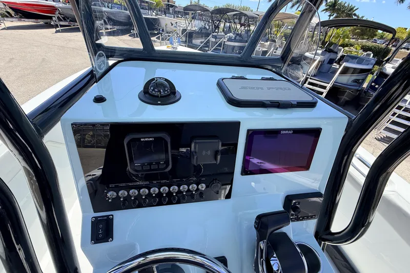 Slide: The Image of 2026 Sea Pro 225FLX Sandbar boat dashboard with navigation instruments and controls. - 26