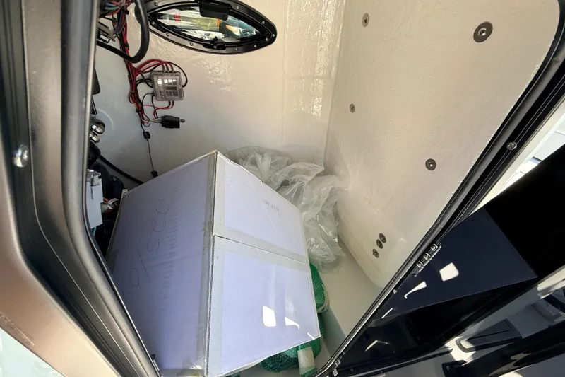 Slide: The Image of Interior storage compartment of 2026 Sea Pro 225FLX Sandbar boat with wiring and a box. - 31