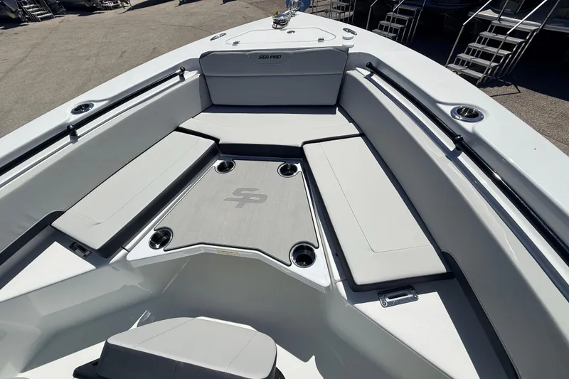 Slide: The Image of 2026 Sea Pro 225FLX Sandbar boat interior with cushioned seating and cup holders. - 32