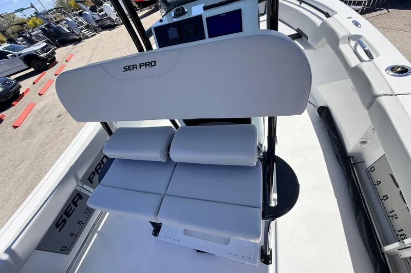 Slide: The Image of 2026 Sea Pro 225FLX Sandbar boat interior with cushioned seating and control panel. - 36