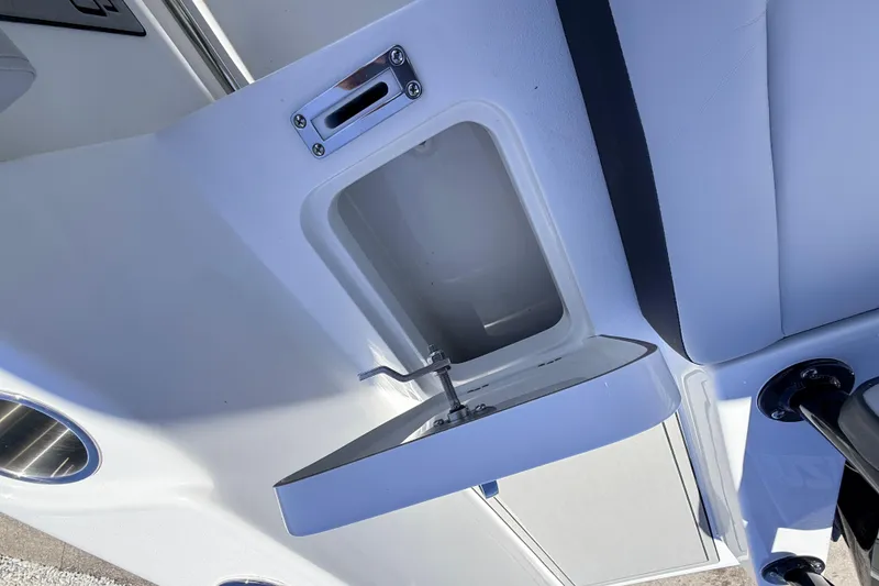 Slide: The Image of 2026 Sea Pro 225FLX Sandbar boat compartment with open storage and latch. - 38