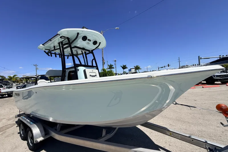 Slide: The Image of 2026 Sea Pro 225FLX Sandbar boat on trailer under clear blue sky. - 5