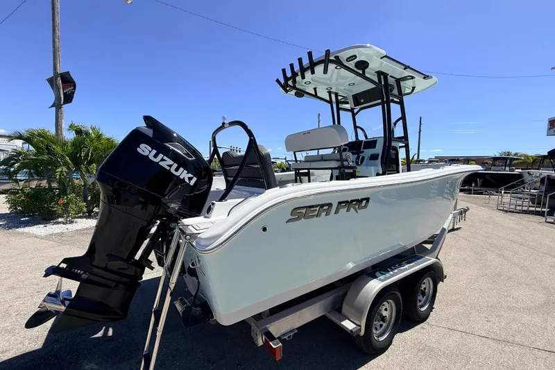 Slide: The Image of 2026 Sea Pro 225FLX Sandbar boat with Suzuki engine on trailer, sunny day. - 6