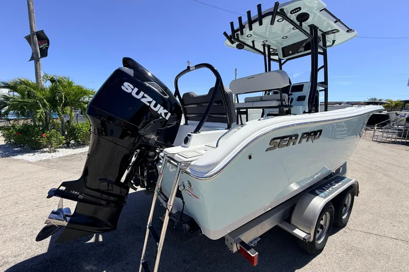 Slide: The Image of 2026 Sea Pro 225FLX Sandbar boat with Suzuki engine on trailer, sunny day. - 8