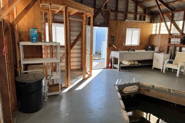 Slide: The Image of Interior of a 1960 custom boathouse with rustic wooden walls and simple furnishings. - 10