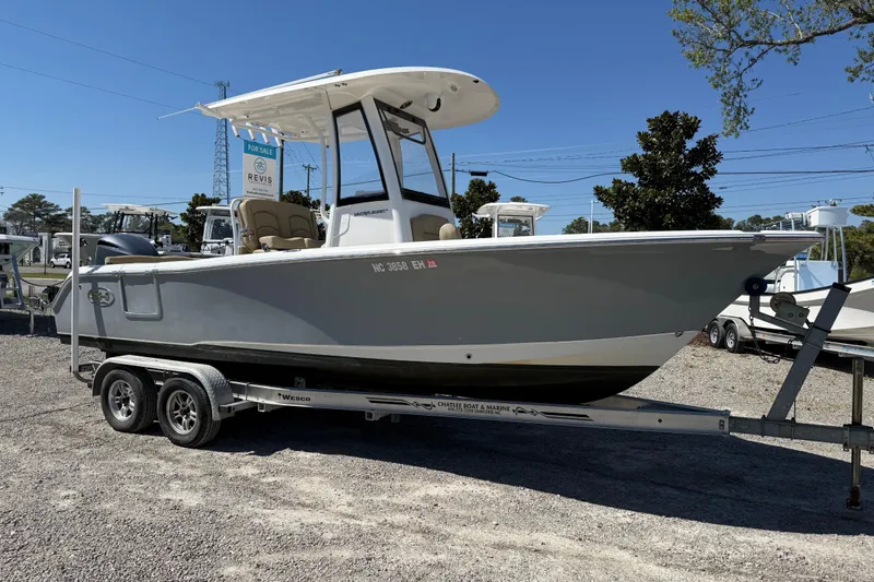 Slide: The Image of 2018 Sea Hunt Ultra 235 SE boat on trailer, displayed outdoors for sale. - 11