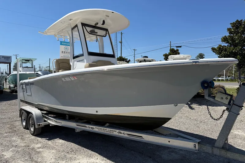Slide: The Image of 2018 Sea Hunt Ultra 235 SE boat on trailer, displayed for sale outdoors. - 12