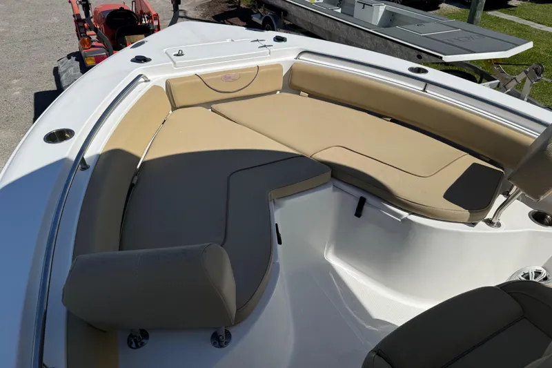 Slide: The Image of 2018 Sea Hunt Ultra 235 SE boat with beige seating and spacious deck layout. - 13