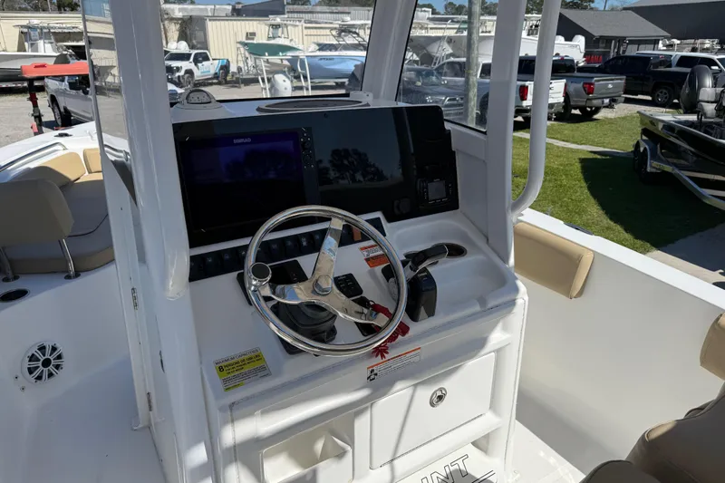 Slide: The Image of 2018 Sea Hunt Ultra 235 SE boat dashboard with steering wheel and navigation display. - 18