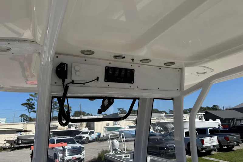 Slide: The Image of 2018 Sea Hunt Ultra 235 SE boat interior with control panel and overhead view. - 19