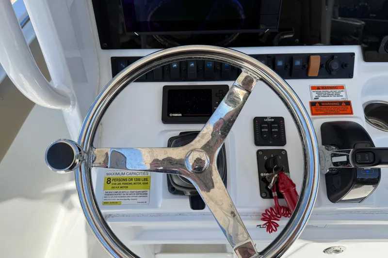 Slide: The Image of Steering wheel and controls of a 2018 Sea Hunt Ultra 235 SE boat. - 21