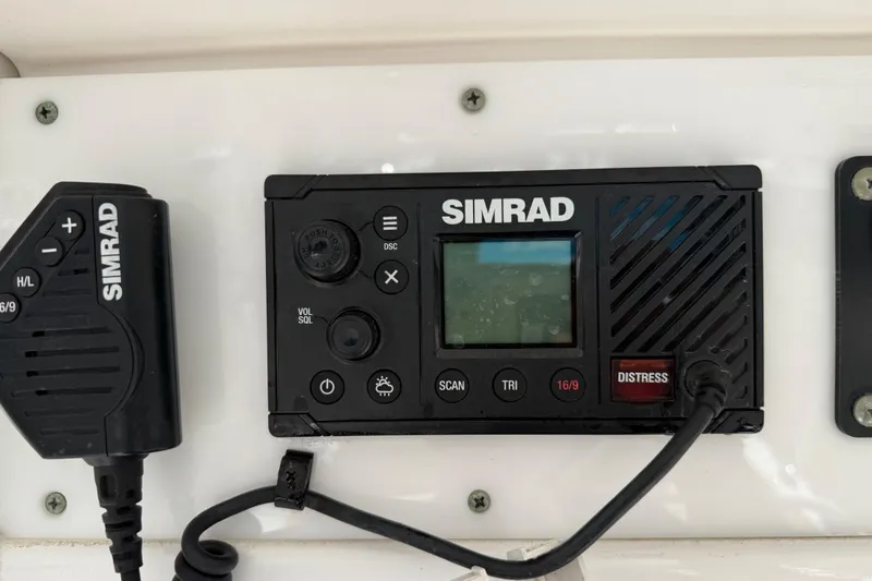 Slide: The Image of Simrad marine radio on 2018 Sea Hunt Ultra 235 SE boat dashboard. - 22