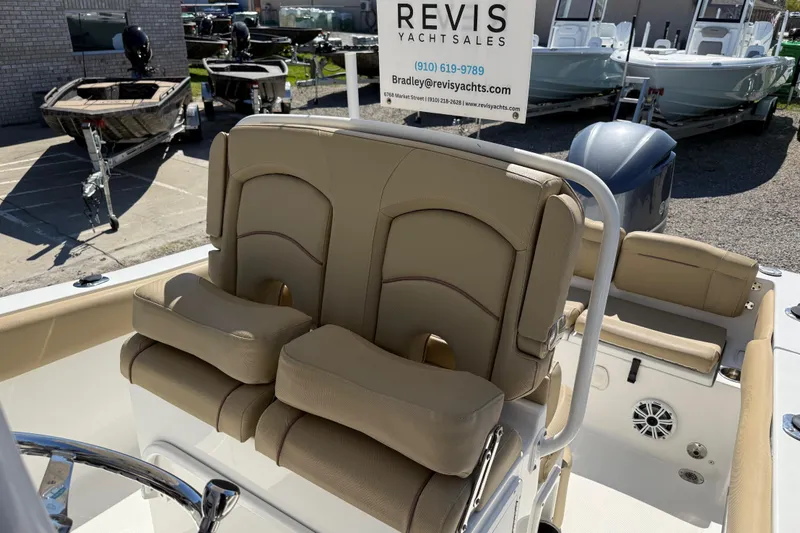 Slide: The Image of 2018 Sea Hunt Ultra 235 SE boat interior with tan seating at Revis Yacht Sales. - 23