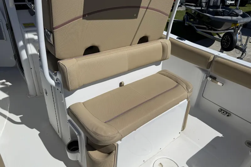 Slide: The Image of 2018 Sea Hunt Ultra 235 SE boat interior with tan cushioned seating. - 28