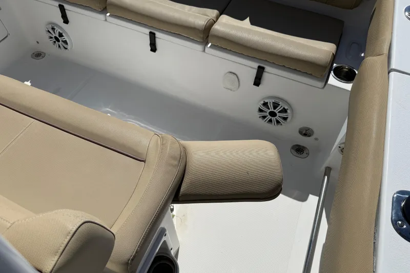 Slide: The Image of 2018 Sea Hunt Ultra 235 SE boat interior with beige seating and speakers. - 29