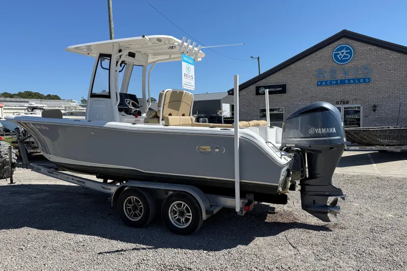 Slide: The Image of 2018 Sea Hunt Ultra 235 SE boat on trailer at Revis Yacht Sales, featuring Yamaha engine. - 3