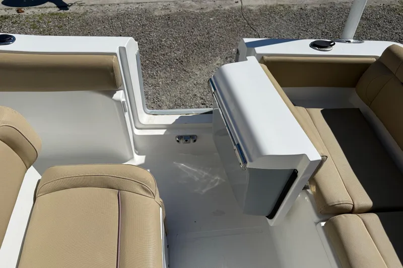 Slide: The Image of 2018 Sea Hunt Ultra 235 SE boat interior with beige seating and white accents. - 32