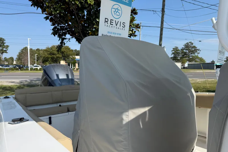 Slide: The Image of 2018 Sea Hunt Ultra 235 SE boat with covered seating, displayed outdoors. - 34