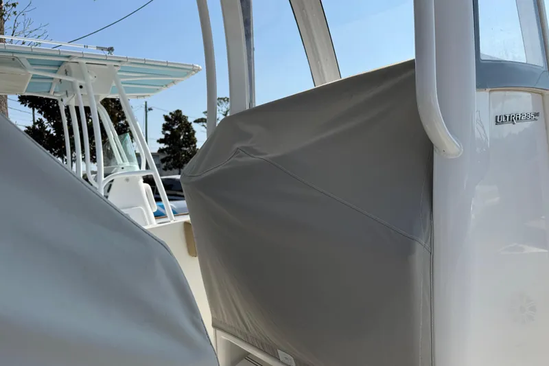 Slide: The Image of 2018 Sea Hunt Ultra 235 SE boat with protective cover, showcasing sleek design. - 35